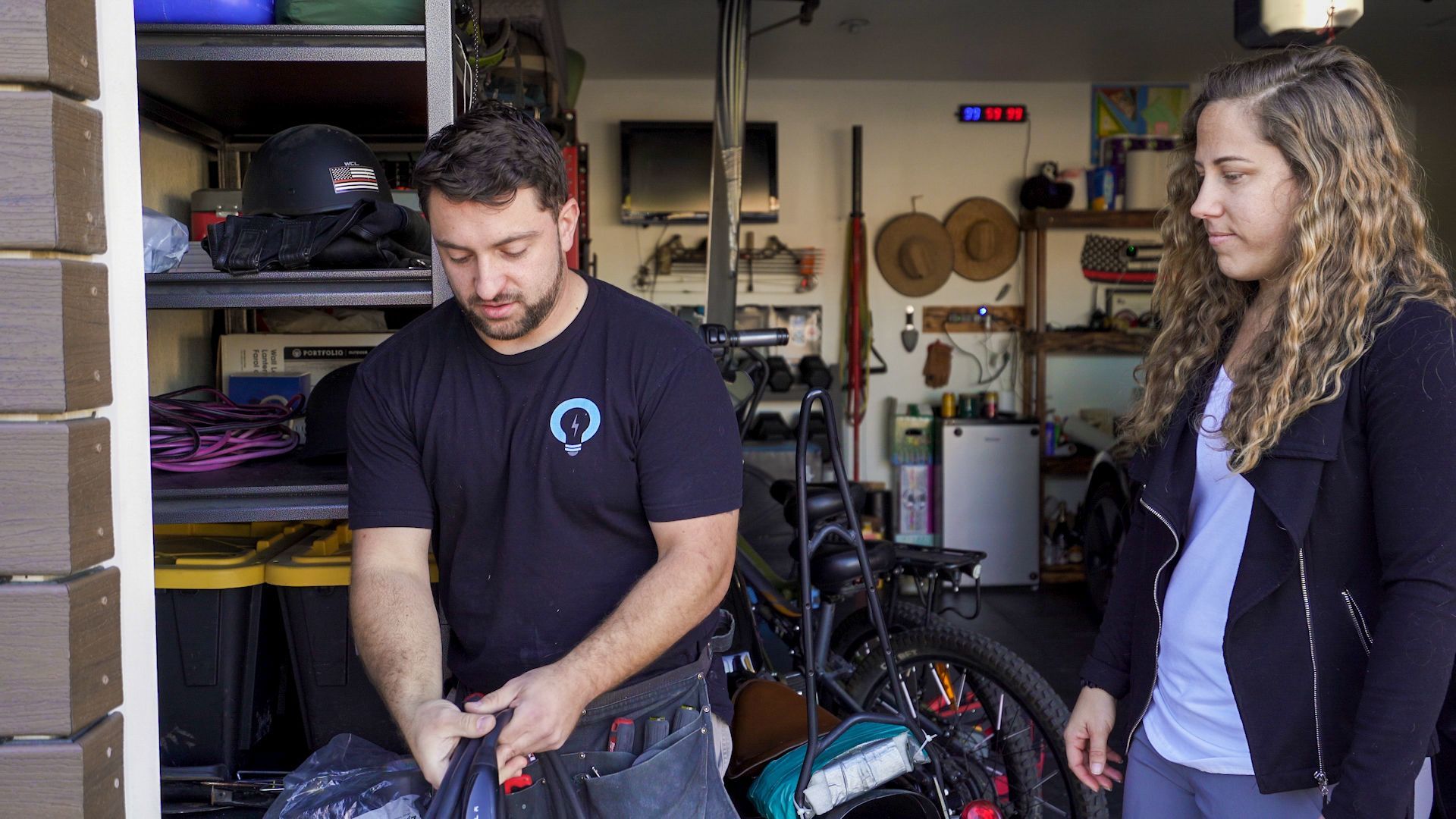 a man and a woman are standing in a garage