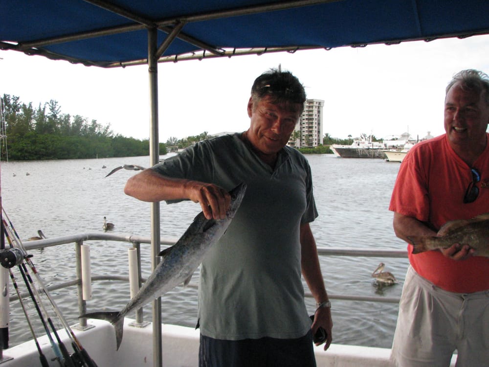 Man with Small Gray Fish — Fort Myers, FL — Captain Tony’s Fishing Adventures