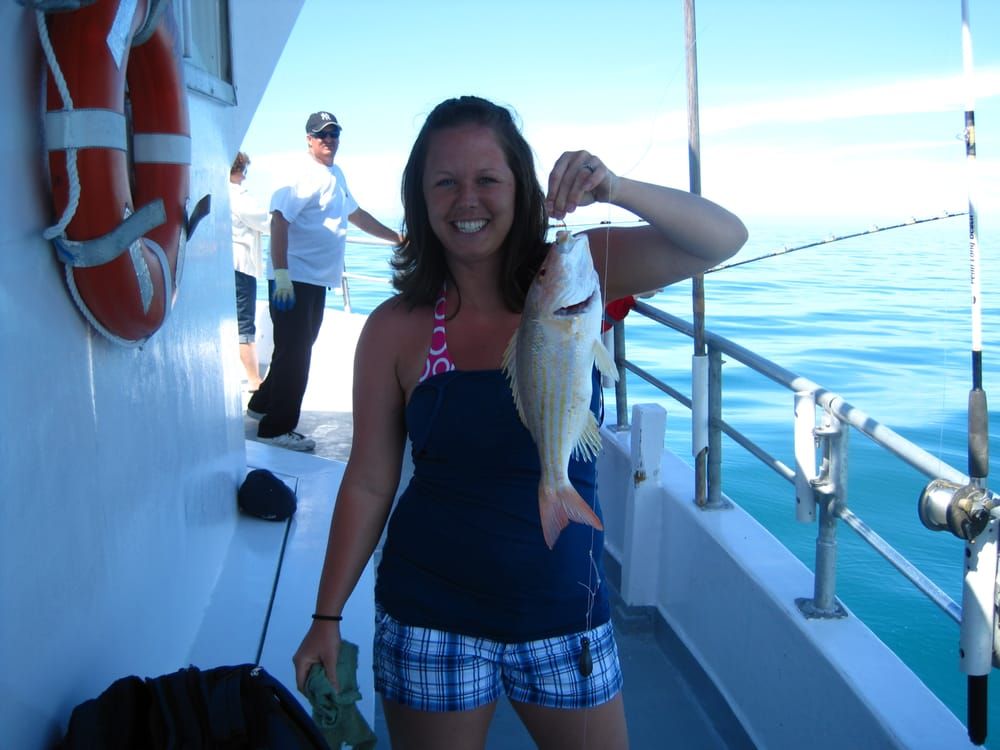 Kid Holding Fish — Fort Myers, FL — Captain Tony’s Fishing Adventures