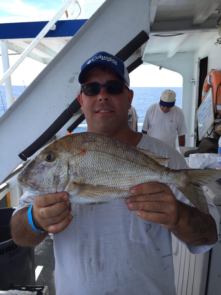 Man Holding Flat Fish — Fort Myers, FL — Captain Tony’s Fishing Adventures