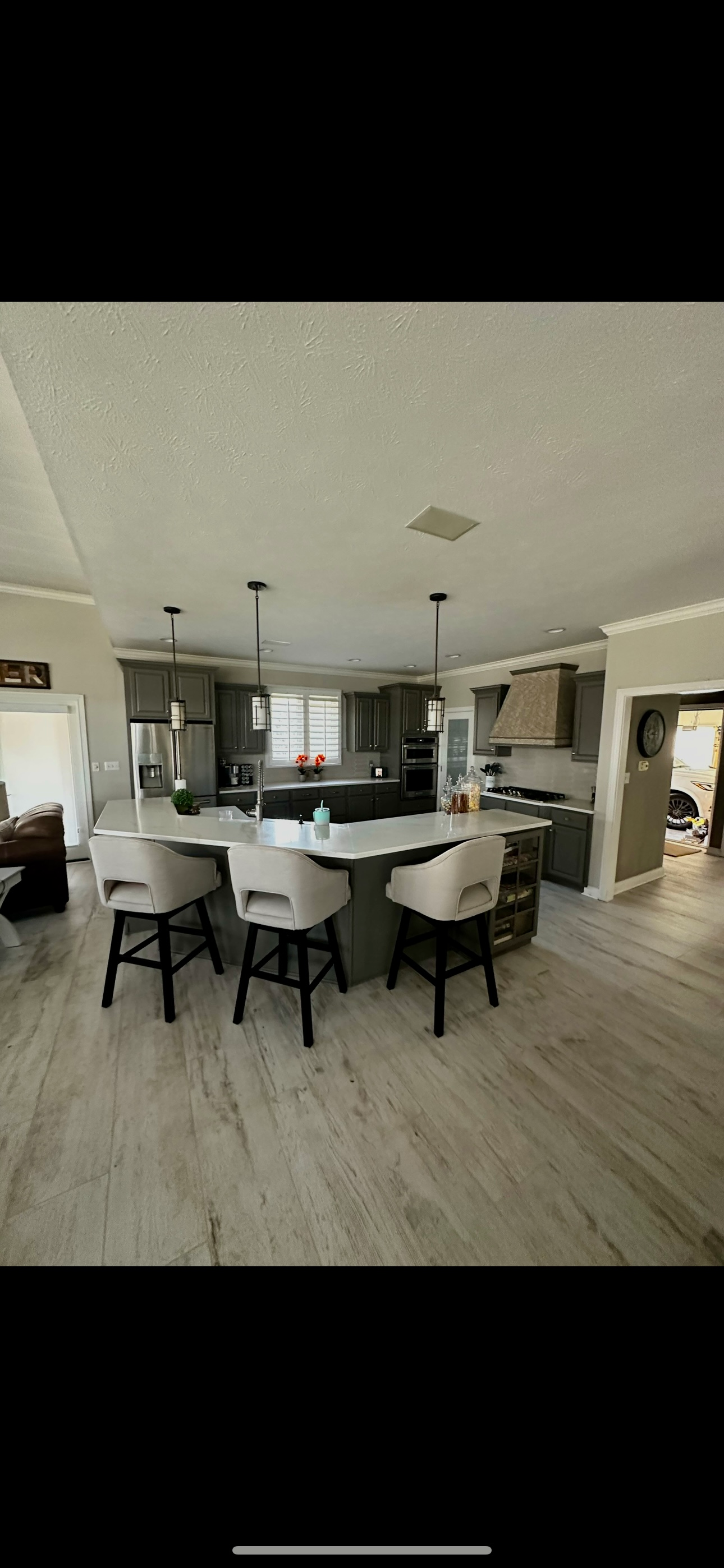 A kitchen with a table and chairs in it.