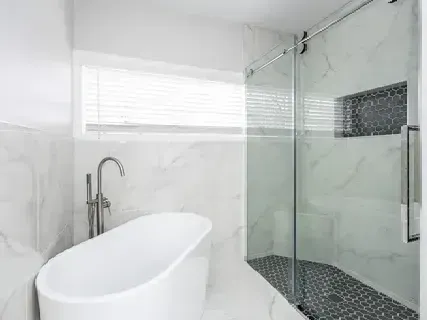 A bathroom with a bathtub and a walk in shower.