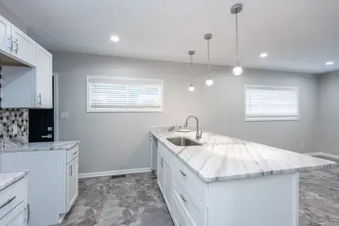 There is a large island in the middle of the kitchen.