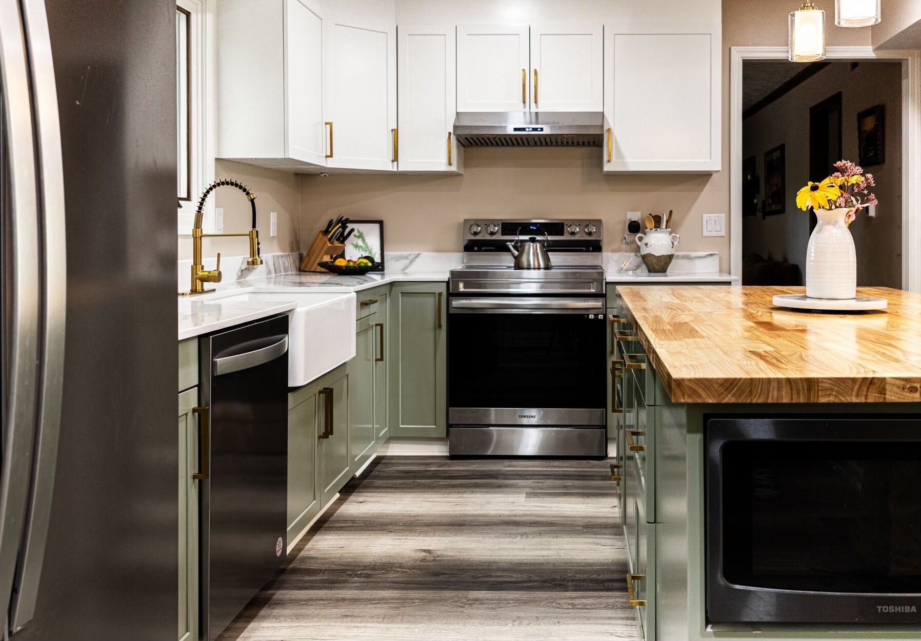 remodeled kitchen with white cupboards and green island