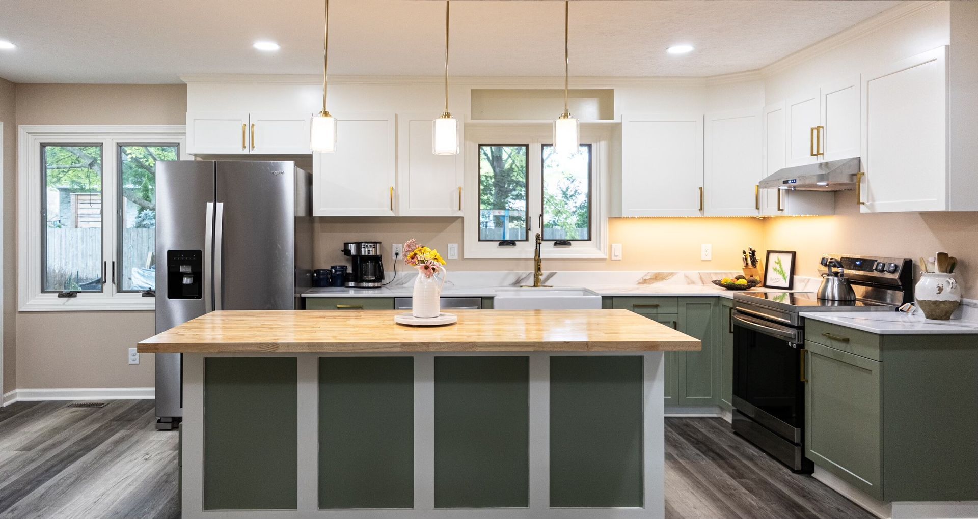 remodeled kitchen with green island and white outlining