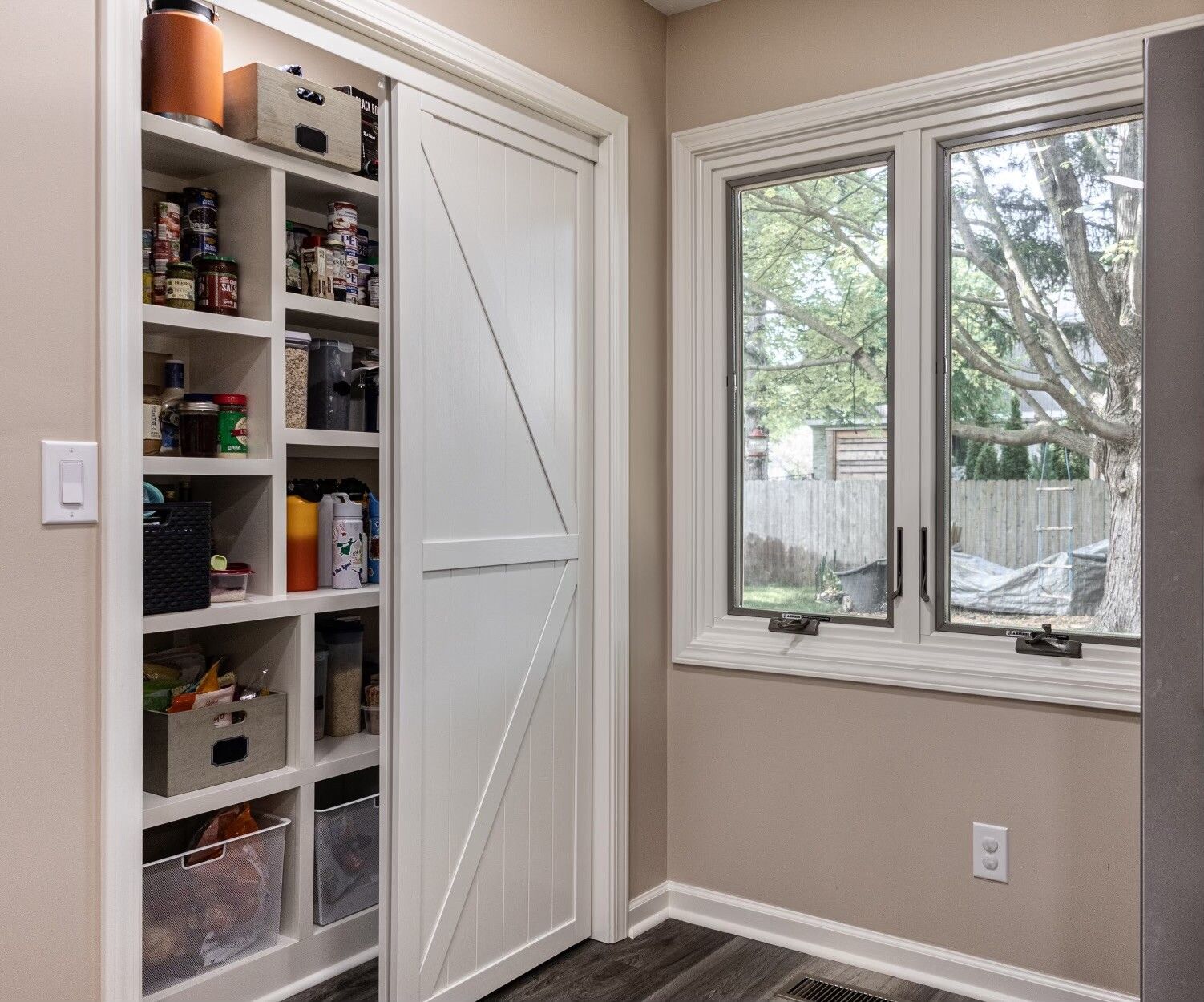 A kitchen with stainless steel appliances and white cabinets.