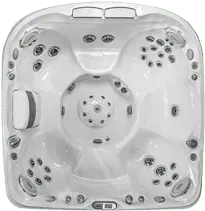 A white hot tub with a lot of jets on a white background.