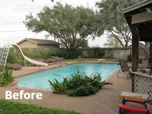 A large swimming pool with a slide in the backyard
