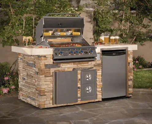 An outdoor kitchen with a grill and a dishwasher