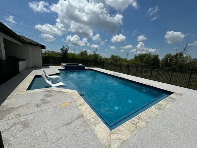 A large swimming pool with a fence around it