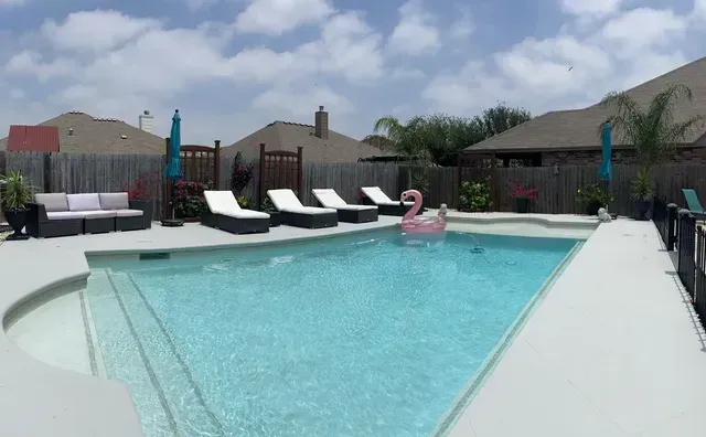 A large swimming pool with a pink flamingo in it