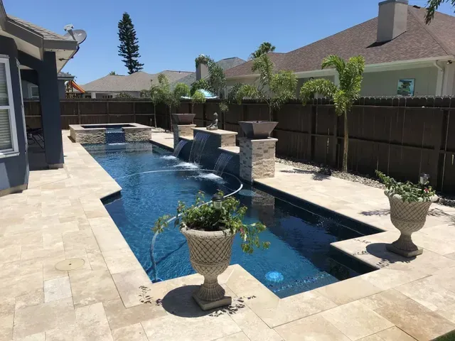 A large swimming pool in the backyard of a house