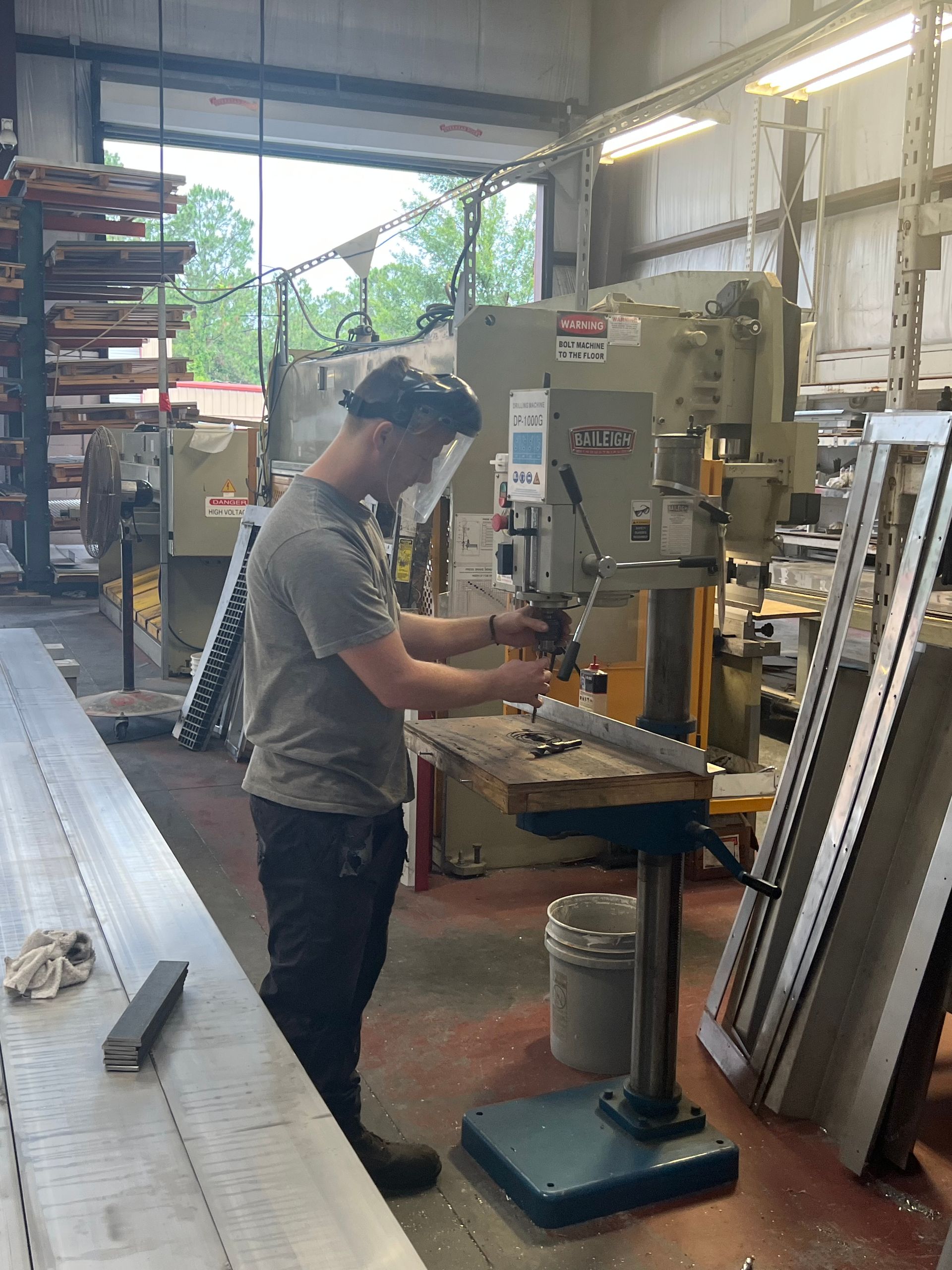 A man wearing a safety helmet is working on a machine that says jct on it