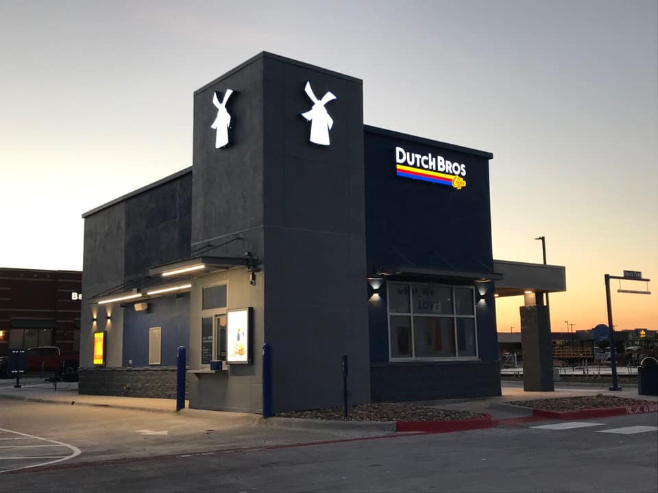 A dutch bros restaurant is located in a parking lot