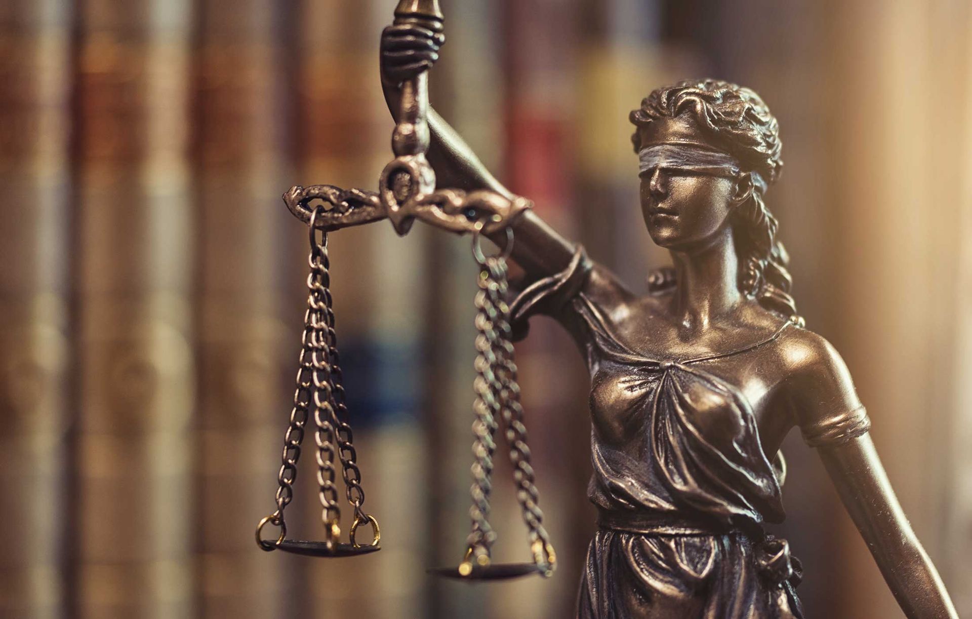 A statue of a blindfolded lady justice holding a scale.