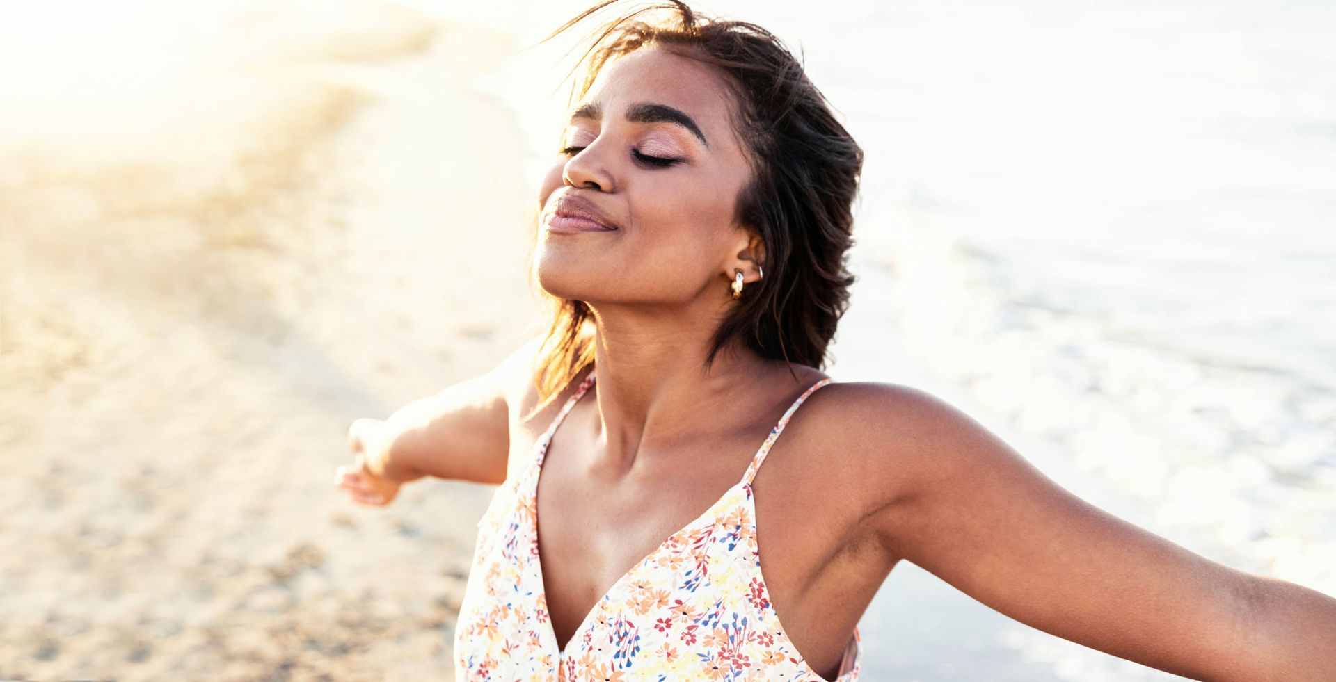 Joyful woman with open arms enjoying nature