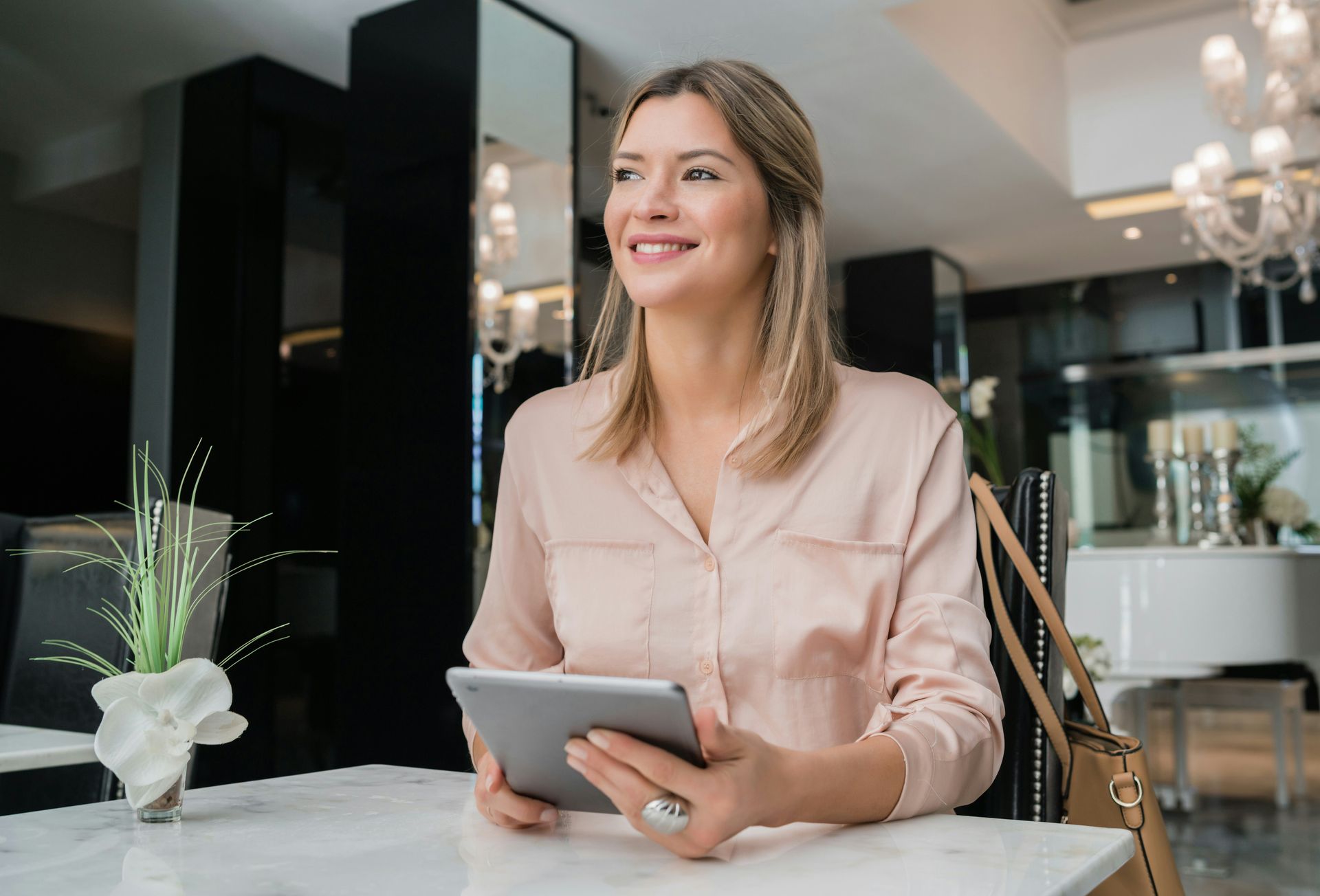 Young businesswoman smiling while working on her digital tablet