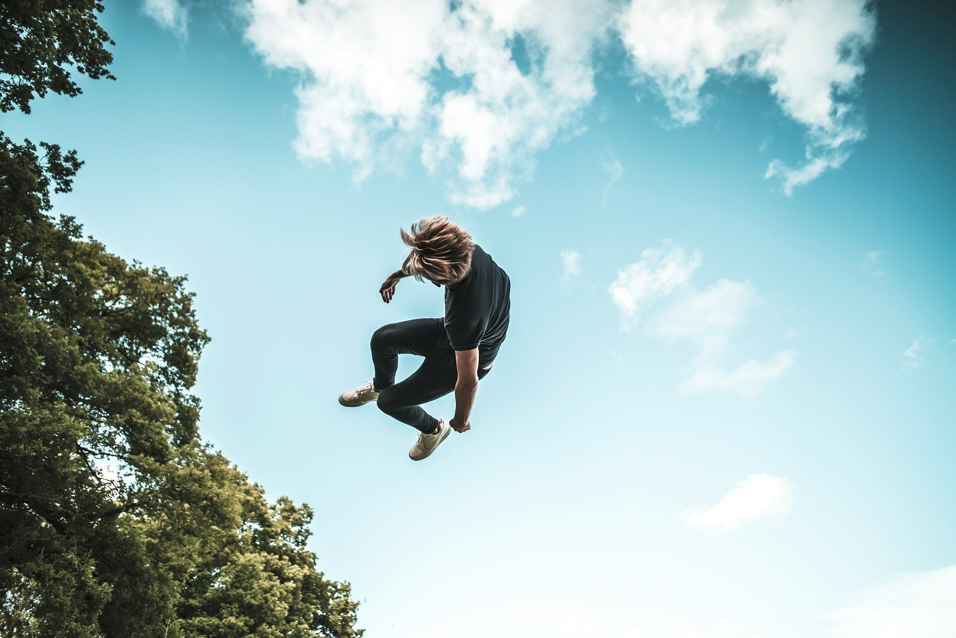 A man flying through the air while riding a skateboard