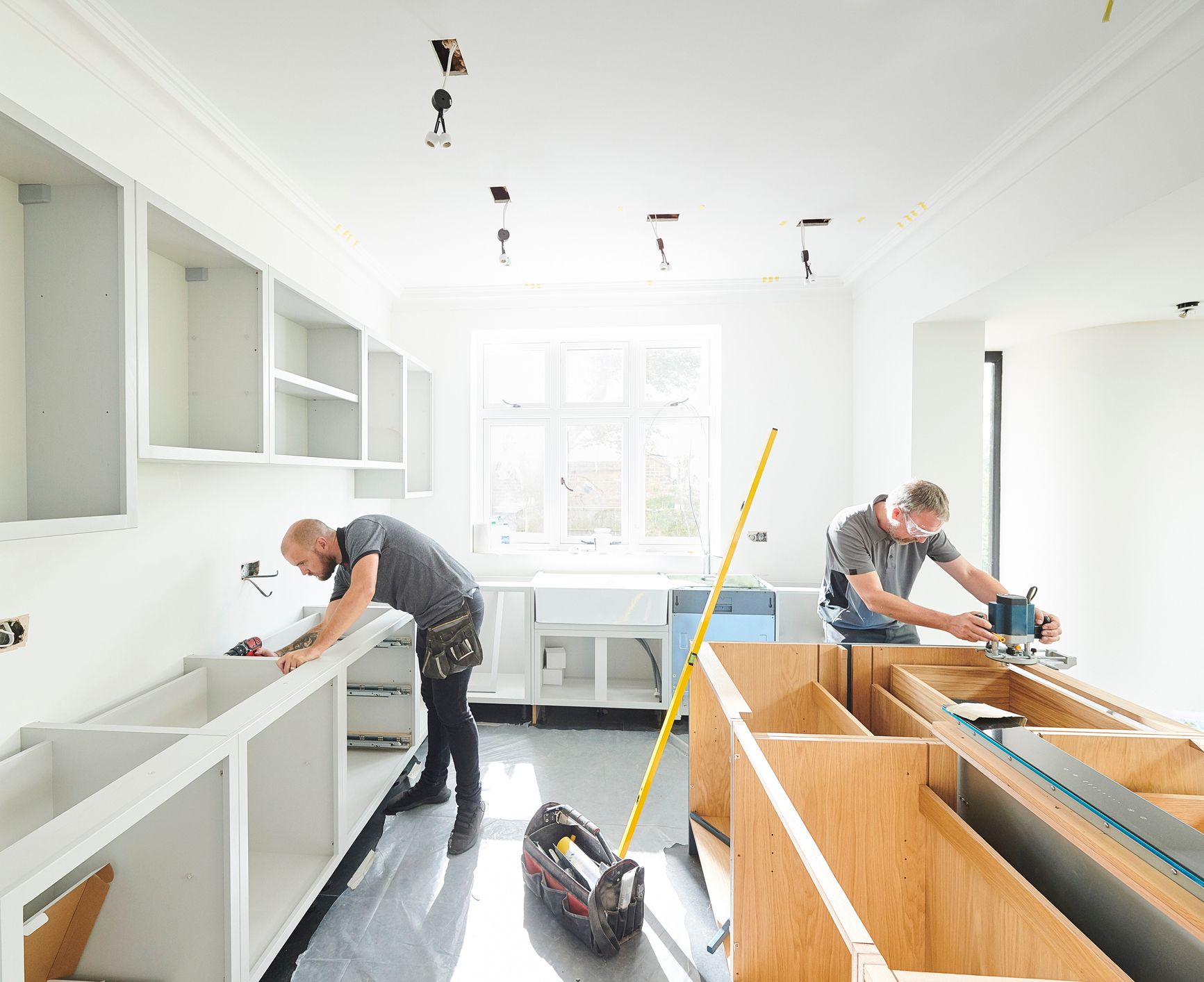 Two Men are Working in a Kitchen Under Construction — Clifton, NJ — New Alp Construction