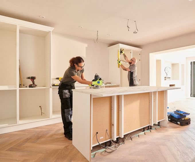 A Man and a Woman are Working on a Kitchen Island — Clifton, NJ — New Alp Construction