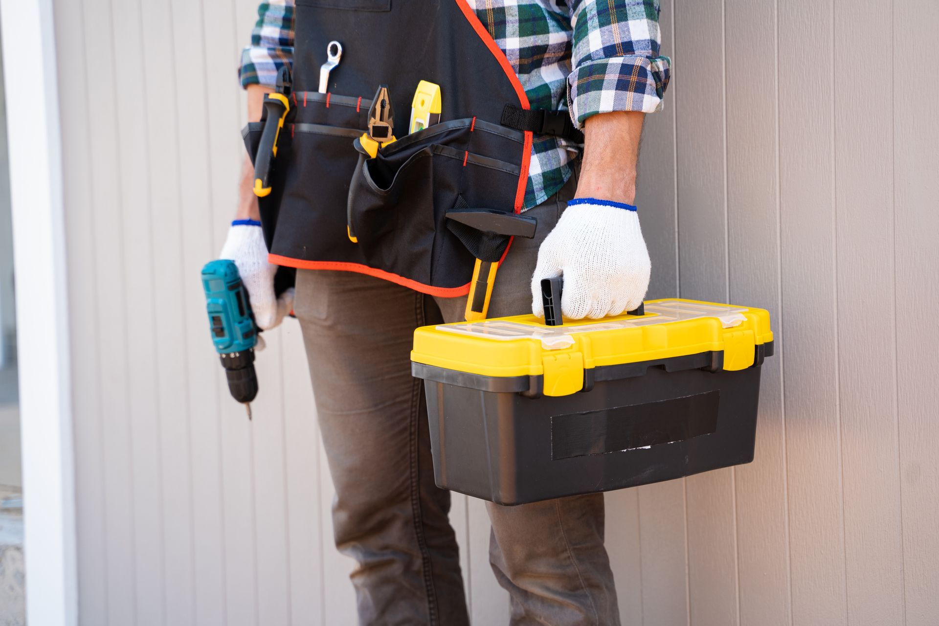 A man is holding a toolbox and a drill — Clifton, NJ — New Alp Construction