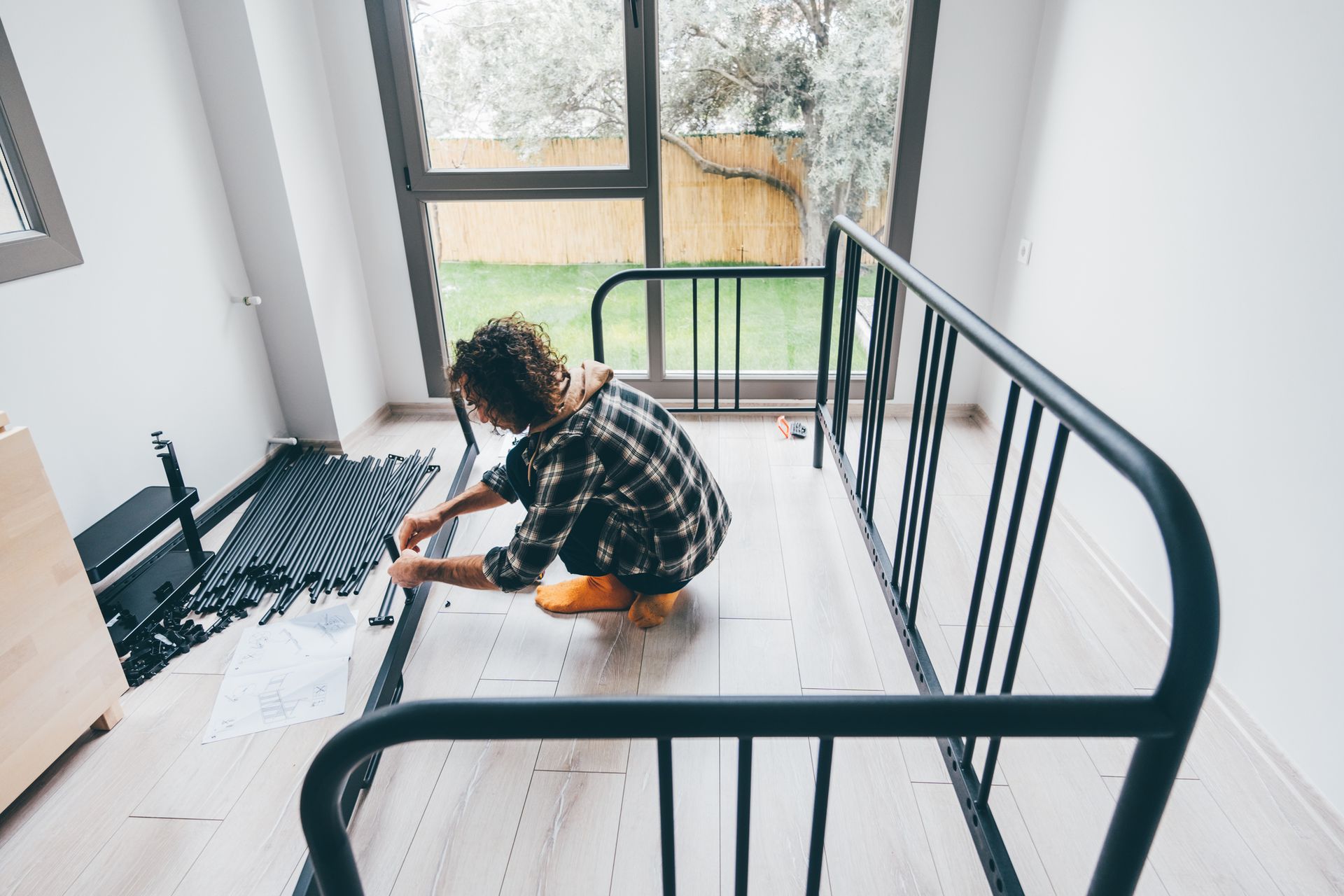 Man assembling furniture in new house — Clifton, NJ — New Alp Construction