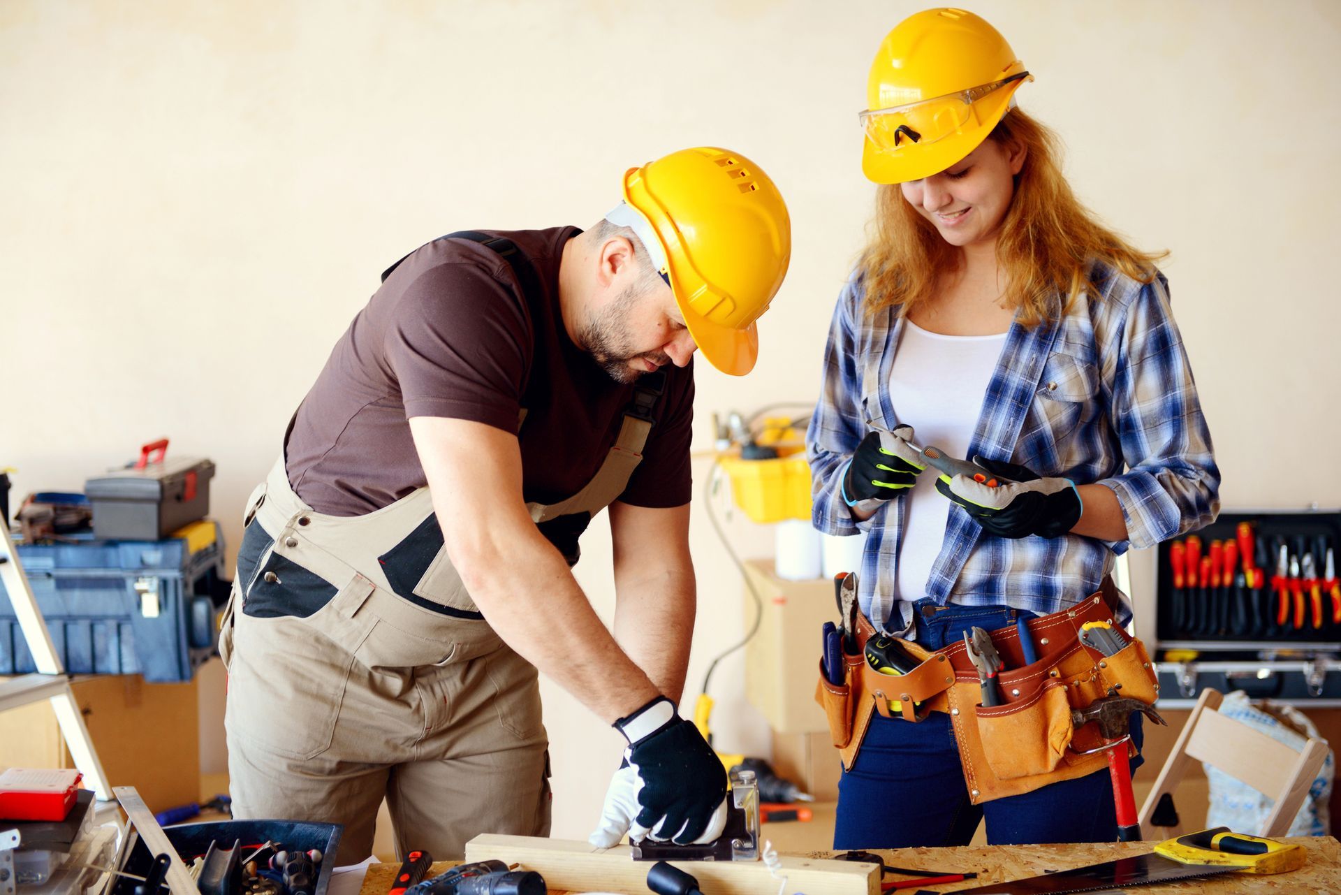 A man and a woman are working on a piece of wood — Clifton, NJ — New Alp Construction