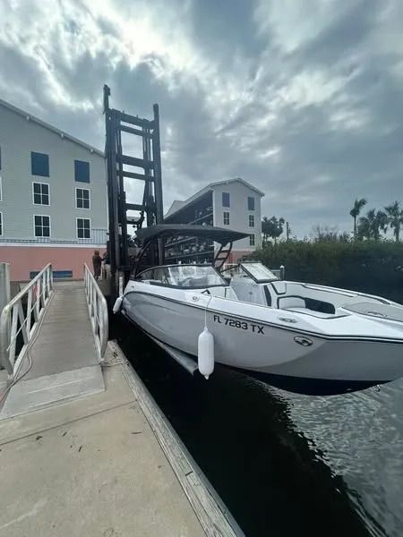 A boat is docked at a dock next to a building.