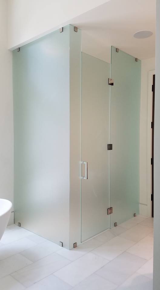 foggy glass enclosed shower with stand alone swinging door