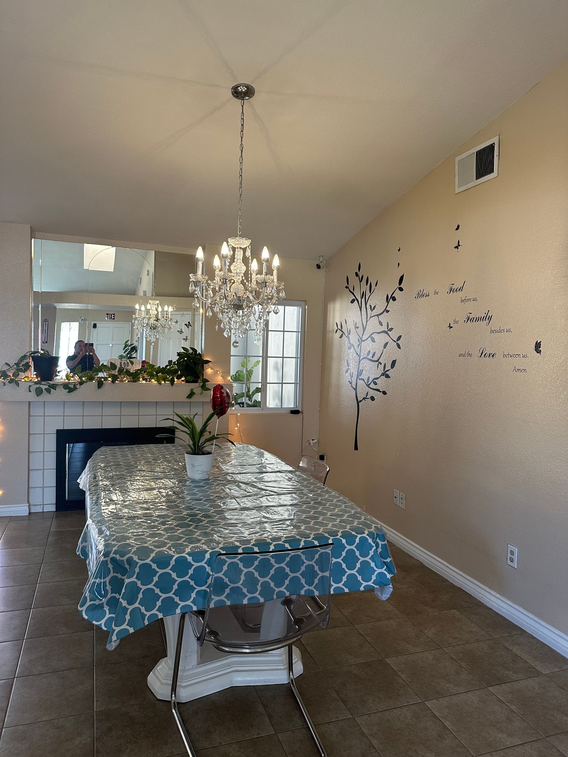 Caregiver assisting person up stairs, white railing. Bright room, natural light.