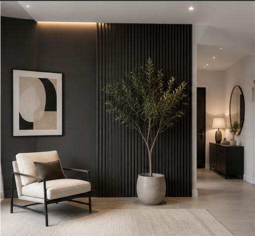 Modern minimalist living room with black accent wall, beige chair, abstract art, and potted tree