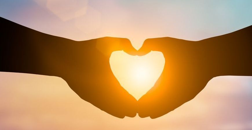 A couple of hands making a heart shape with the sun behind them — Essy K Counselling And Wellness Hub In Croudace Bay NSW