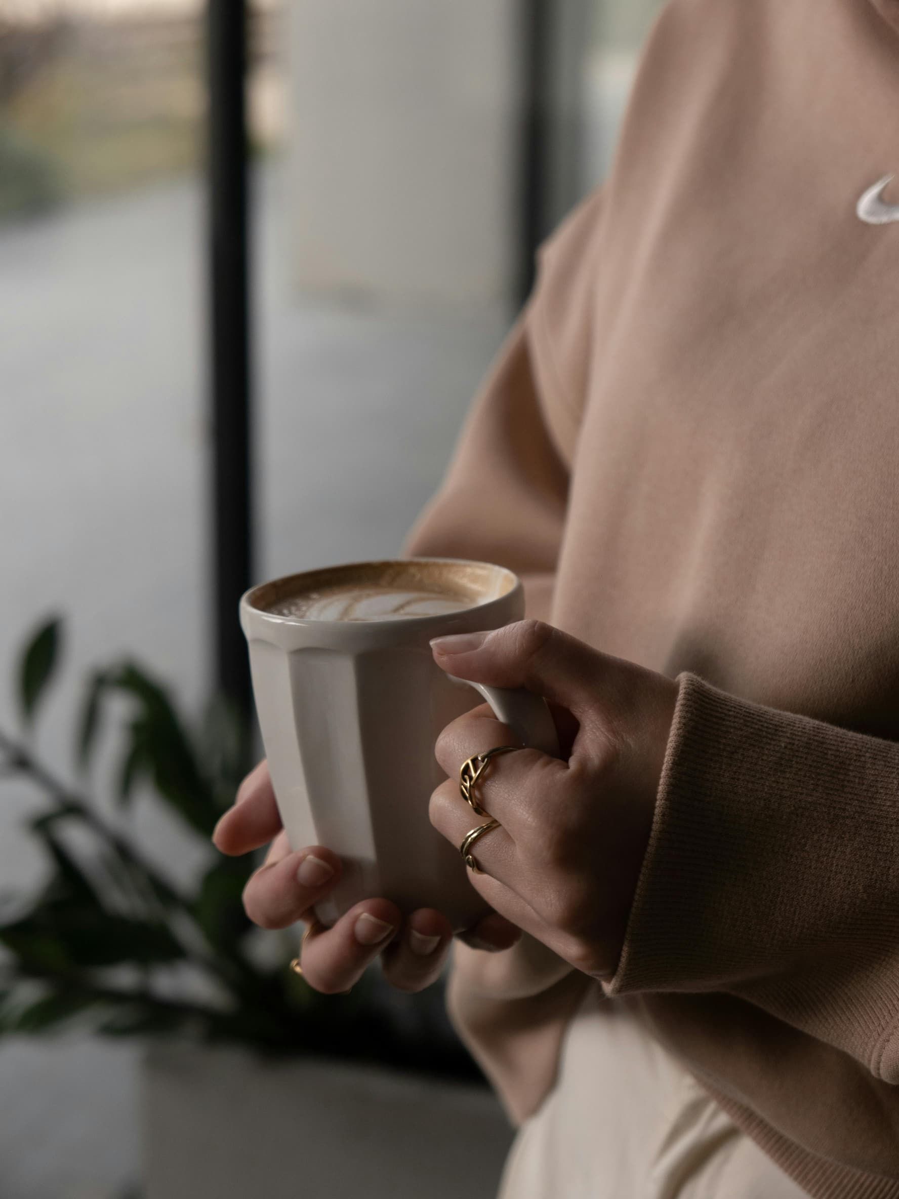 A Woman Holding A Cup Of Coffee — Essy K Counselling And Wellness Hub In Croudace Bay NSW