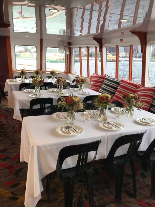 A room with tables and chairs and flowers on them