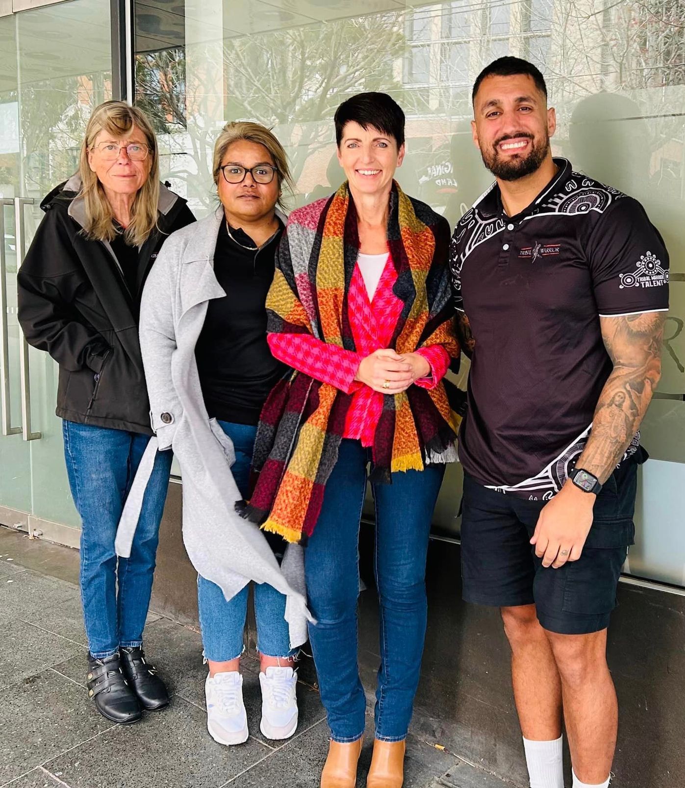 Tribal Warrior staff and Kate Washing MP stand in front of the Tribal Warrior office Redfern