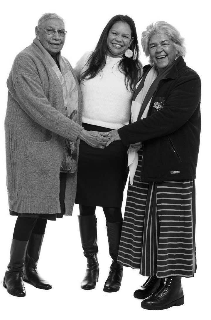 Two women are standing next to each other in a black and white photo.
