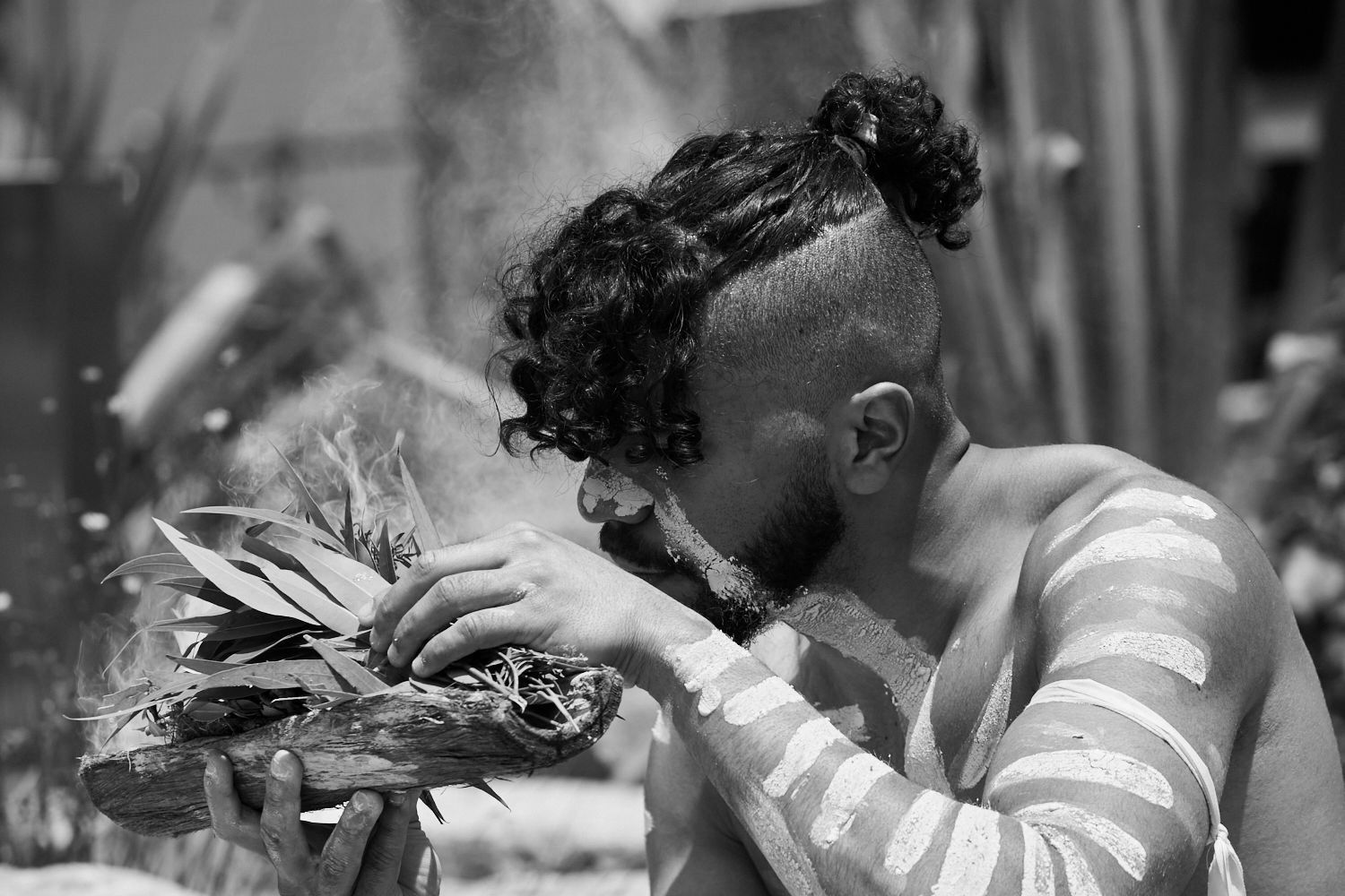 A black and white photo of a man wearing a polo shirt.