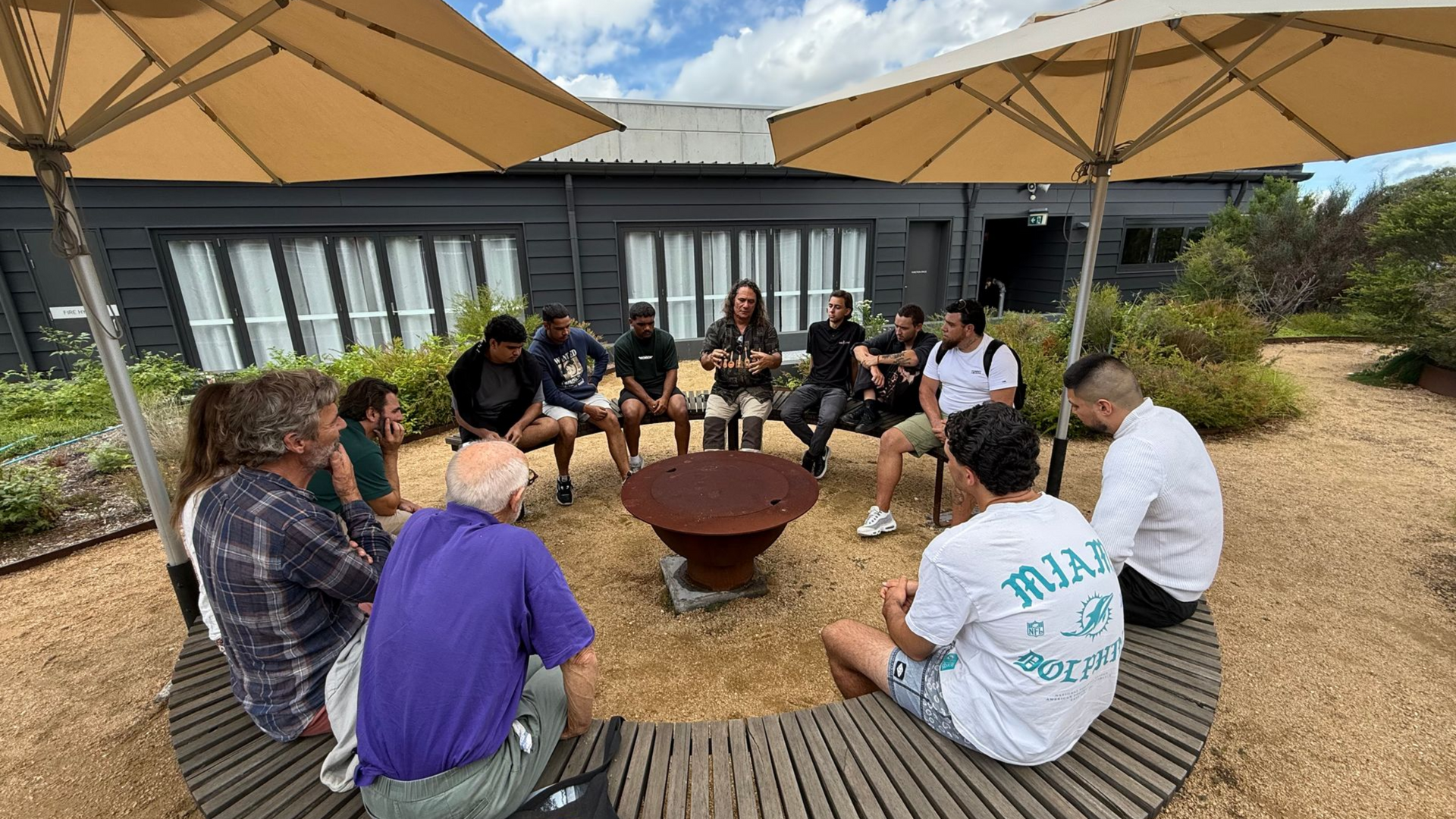 A man with a beard wearing a black polo shirt