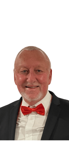 A man in a suit and bow tie is smiling.