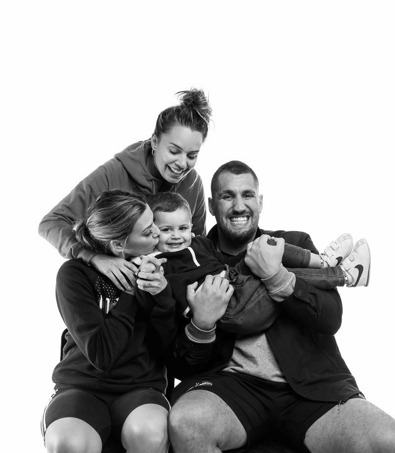 A black and white photo of a family posing for a picture.