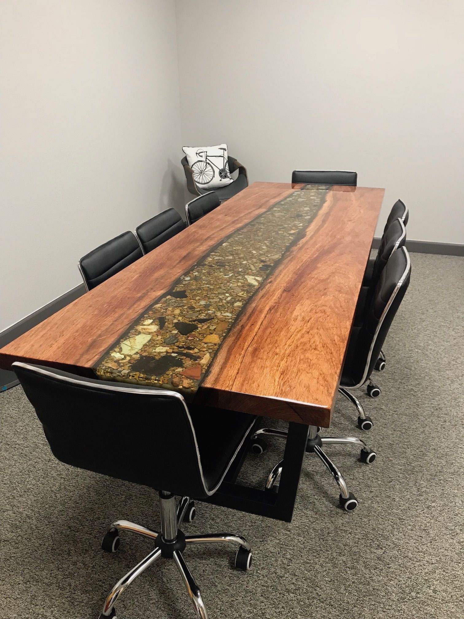 A conference room with a long wooden table and chairs.