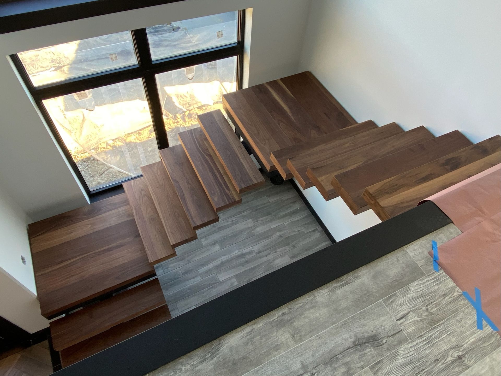 An aerial view of a wooden staircase in a house.
