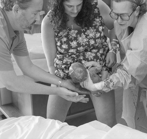 Birth of baby with mother, father and nurse