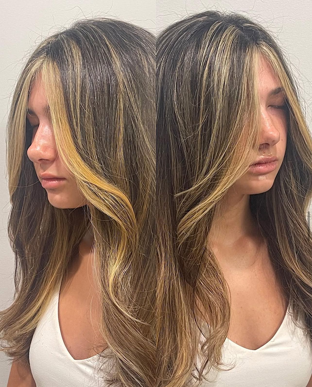 A woman with long hair is standing next to another woman with long hair.