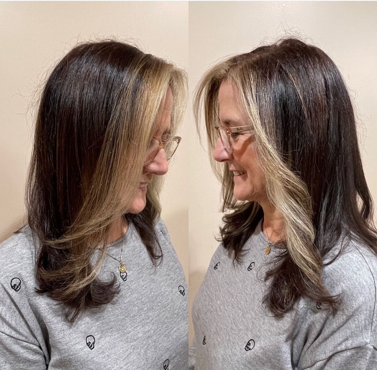 Two women with long hair and glasses are standing next to each other.