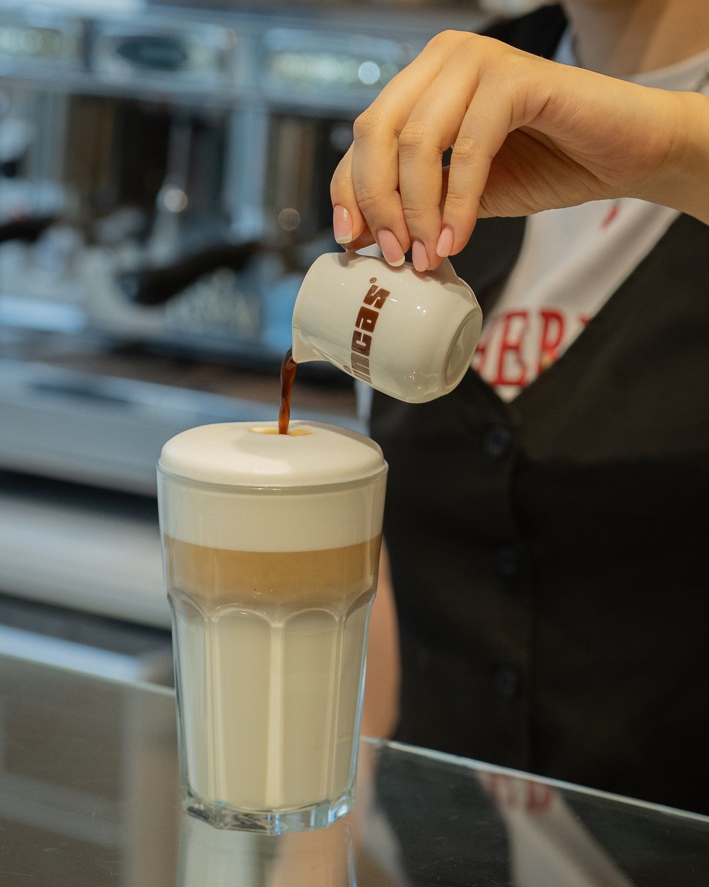 Barista pouring coffee into a layered latte in a clear glass.Domenica
Home made italian pastries, food & coffee