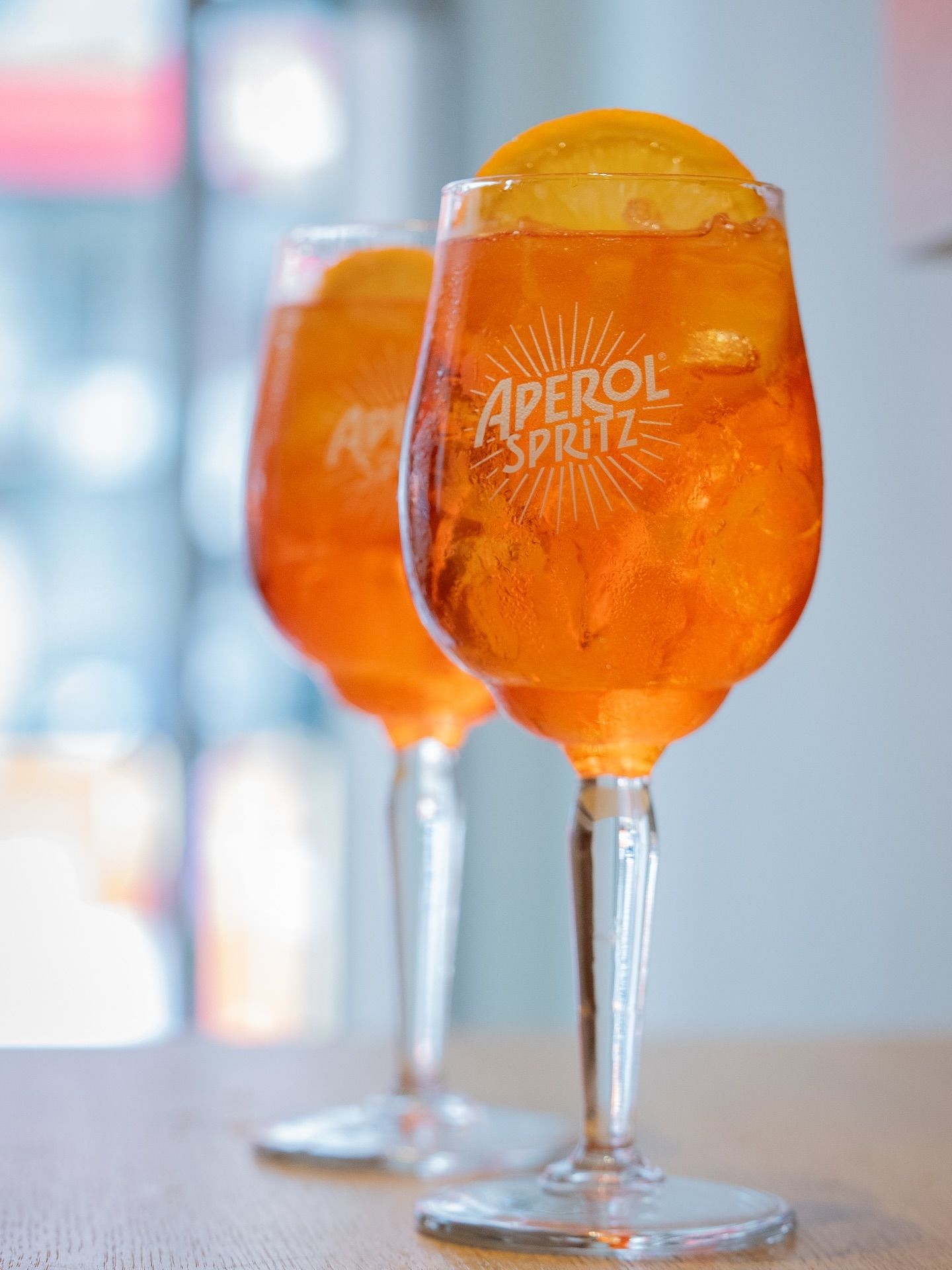 Two Aperol Spritz cocktails with orange slice garnish.Domenica
Home made italian pastries, food & coffee