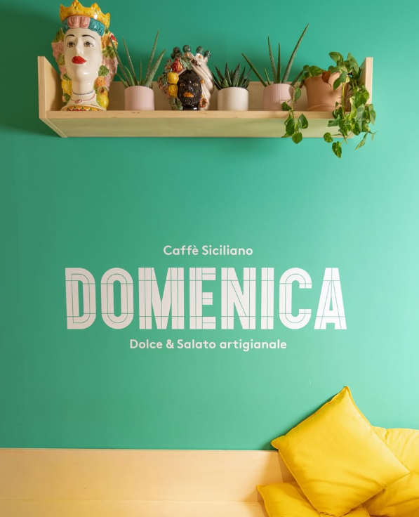 Pasta carbonara with crispy bacon on a blue and white patterned plate, yellow background.