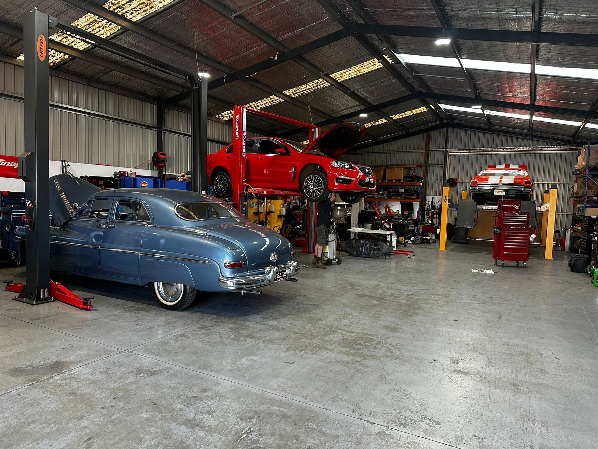 A Blue Car And A Red Car With The Hoods Open — Marsh Mechanics and Auto Electrical in Maddingley, VIC