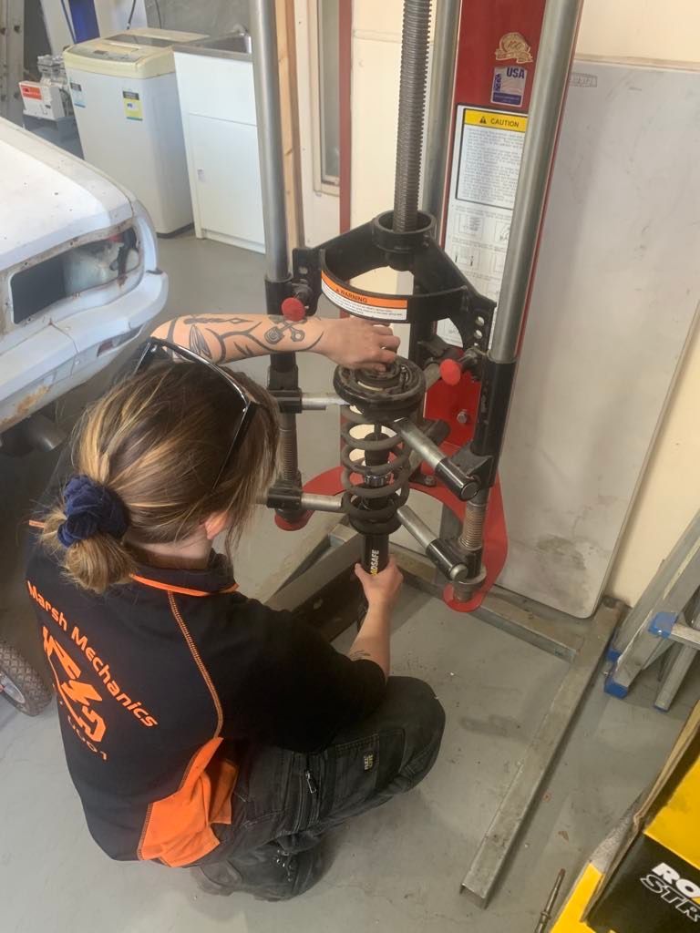 A Woman Working On A Suspension Repair — Marsh Mechanics and Auto Electrical in Maddingley, VIC